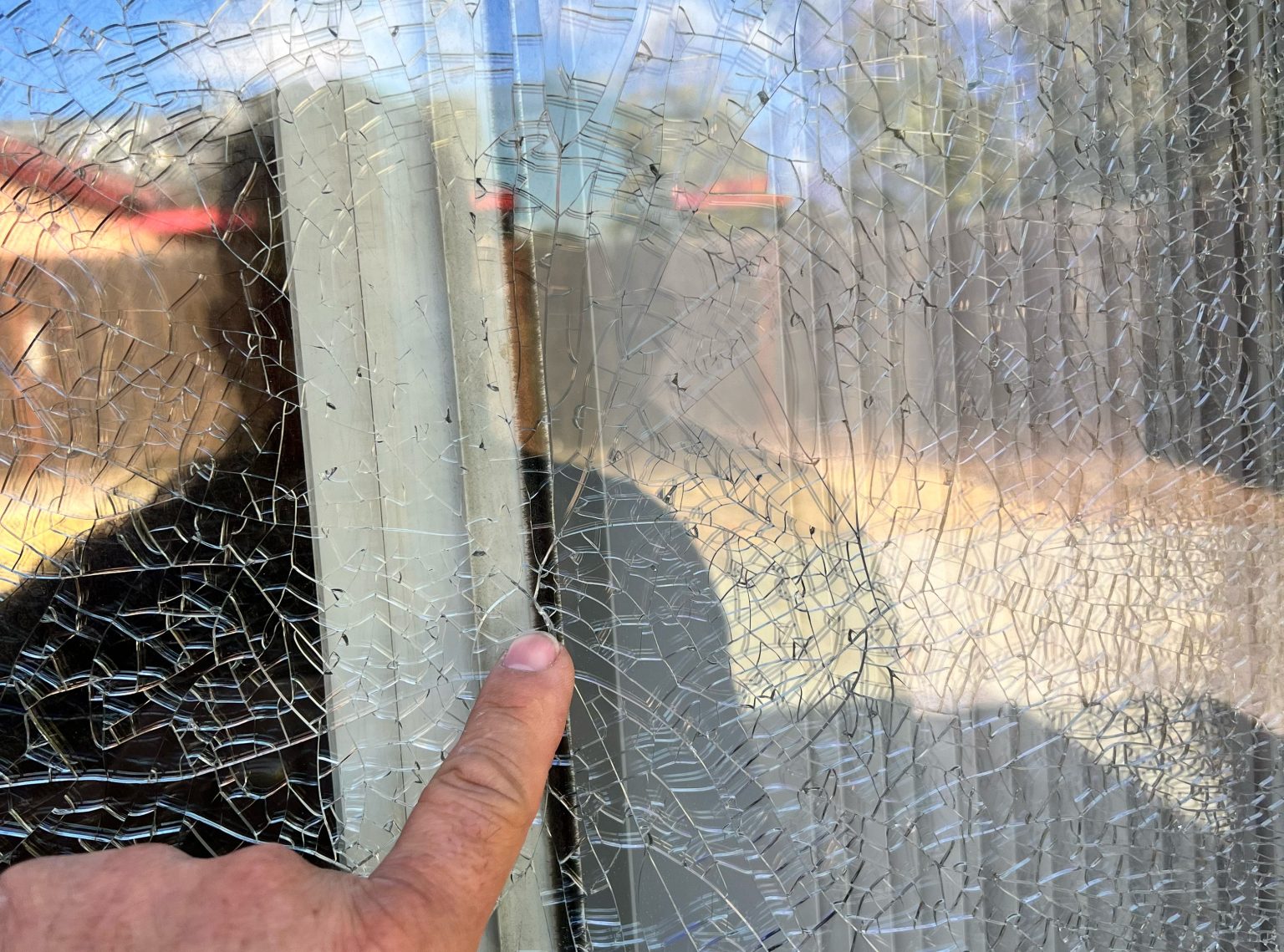 Ricky V - Replacement Glass - Hero Image Finger Pointing at Broken Window Glass